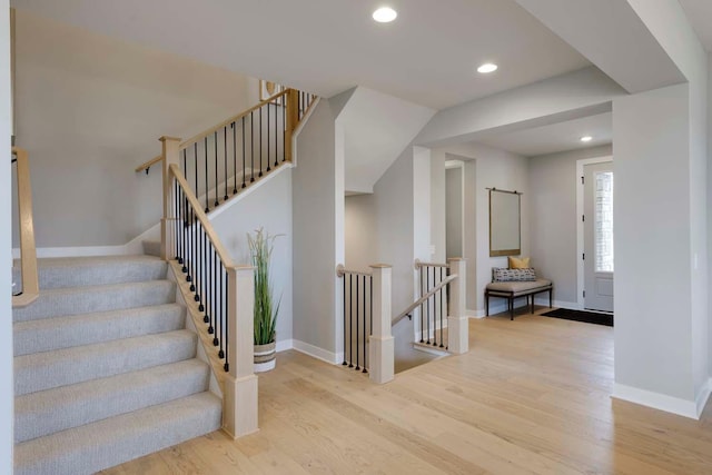 stairway with light wood-type flooring