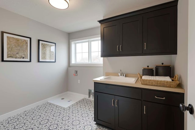 bathroom with sink and tile patterned flooring