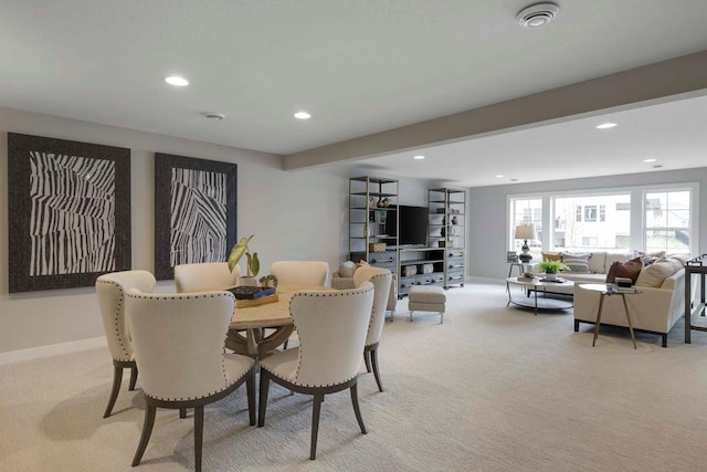 dining space featuring light colored carpet