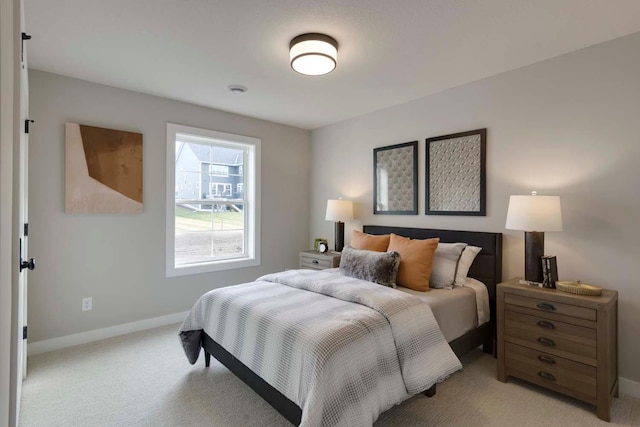 bedroom featuring light colored carpet