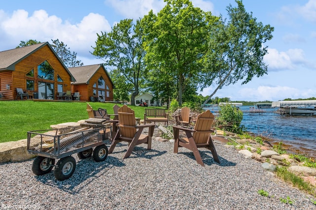 view of yard featuring a water view and a fire pit