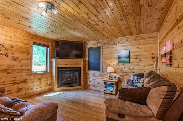 living room with wooden ceiling, light wood-type flooring, and wood walls