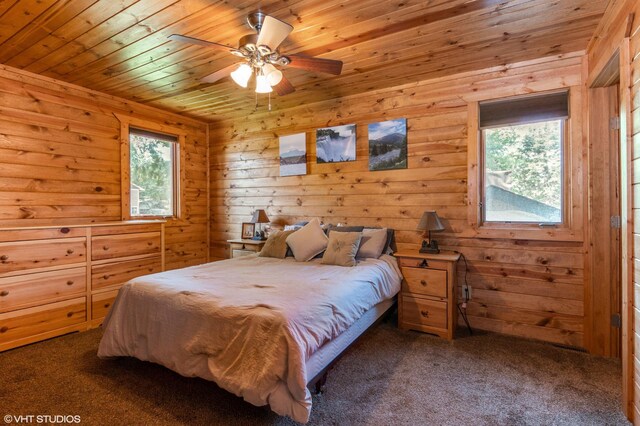 carpeted bedroom with wood ceiling and multiple windows