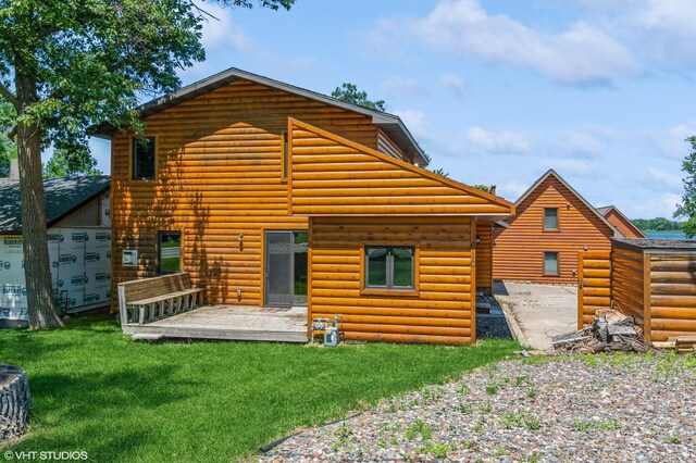 rear view of house with a yard