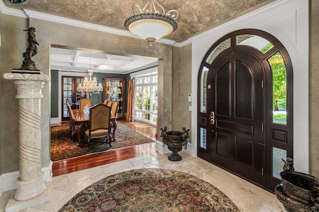 entrance foyer with french doors, beamed ceiling, crown molding, and coffered ceiling