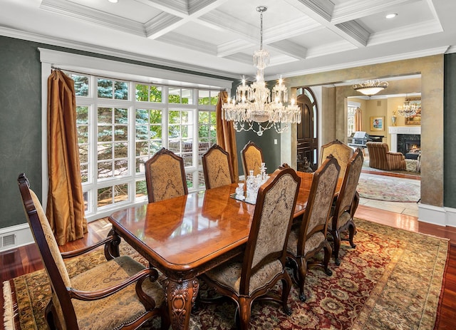 dining space with crown molding, beam ceiling, and wood-type flooring