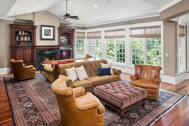 living room featuring vaulted ceiling, a wealth of natural light, dark hardwood / wood-style floors, and a fireplace