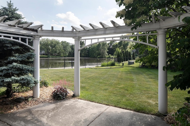 view of yard featuring a pergola and a water view