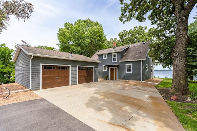 view of front of home with a chimney and a shingled roof