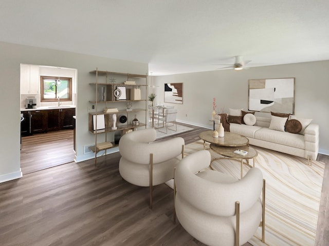 living room with ceiling fan, sink, and wood-type flooring