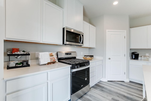 kitchen featuring white cabinetry, light hardwood / wood-style flooring, and stainless steel appliances