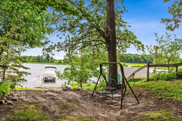 view of yard featuring a dock and a water view