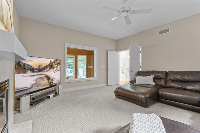 living room with ceiling fan, carpet, and a fireplace