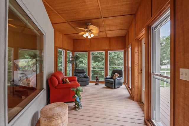 sunroom / solarium with ceiling fan and wood ceiling