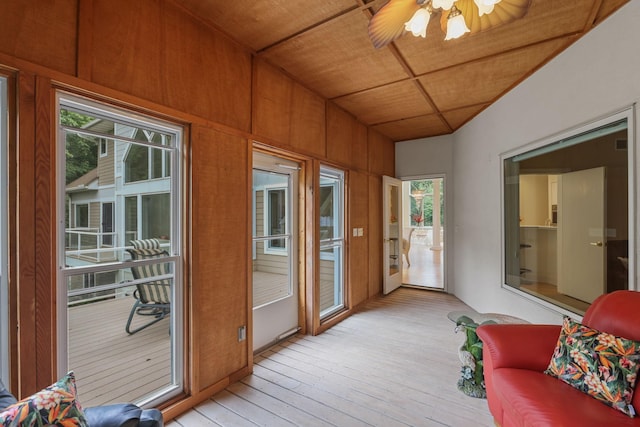 sunroom / solarium featuring ceiling fan and wood ceiling