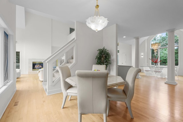 dining area with light hardwood / wood-style flooring and a notable chandelier