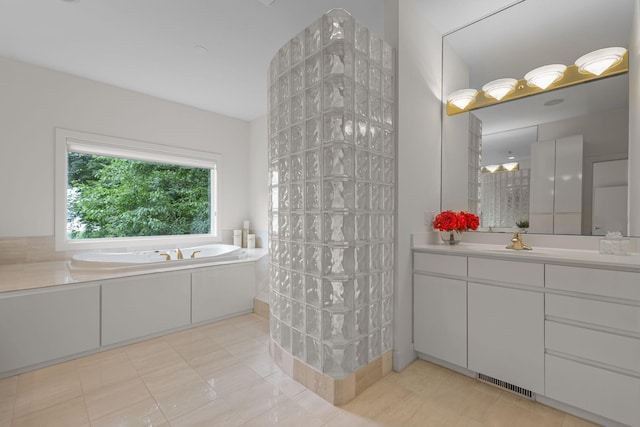 bathroom featuring plus walk in shower, tile patterned flooring, and vanity