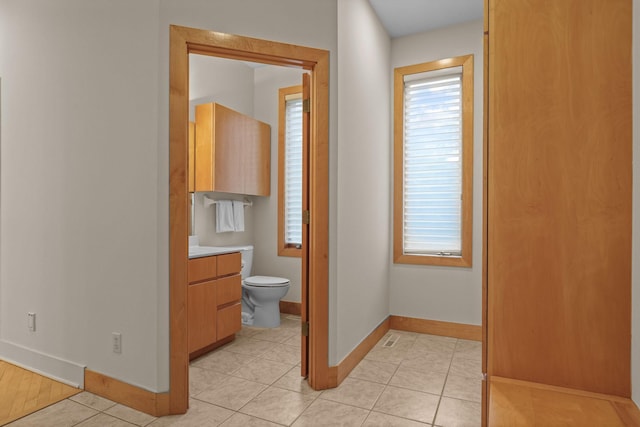 bathroom featuring toilet, vanity, and tile patterned floors