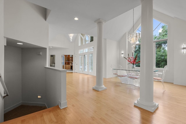 interior space with high vaulted ceiling, light hardwood / wood-style flooring, and a notable chandelier