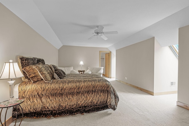 bedroom with vaulted ceiling, ceiling fan, and light colored carpet