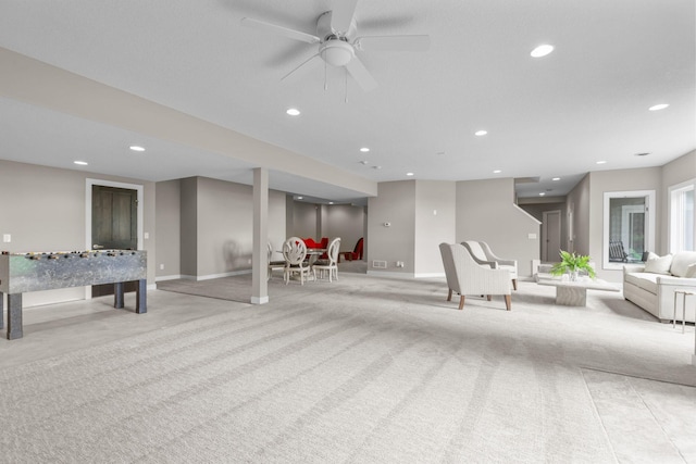 recreation room featuring ceiling fan and light colored carpet