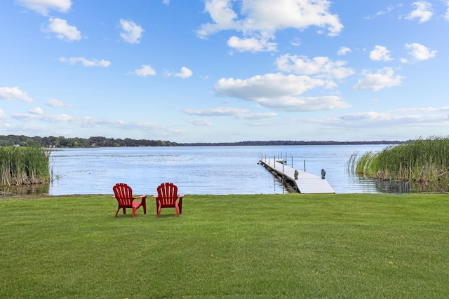 exterior space featuring a lawn and a water view