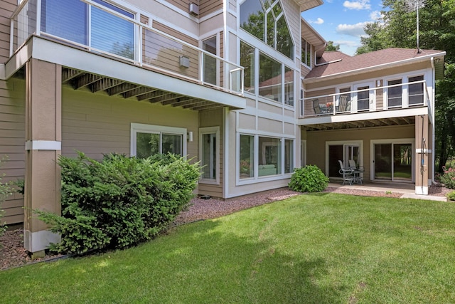 back of house featuring a patio area and a yard