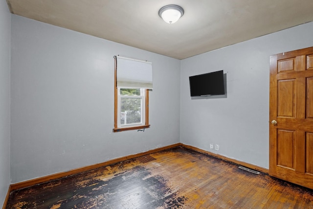 spare room featuring dark hardwood / wood-style floors