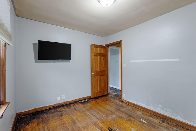 empty room with wood-type flooring