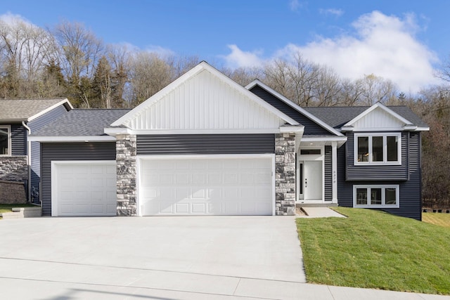 view of front of house with a garage and a front yard