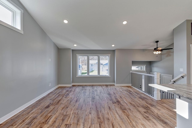 unfurnished living room featuring light wood-type flooring and ceiling fan