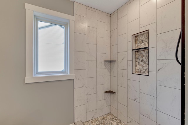 bathroom with a tile shower