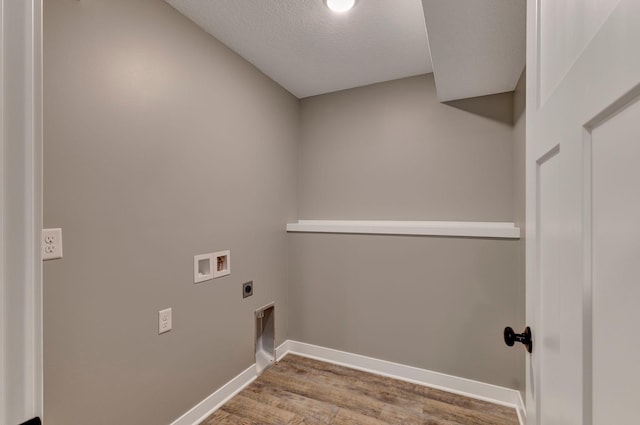 laundry area with washer hookup, a textured ceiling, hookup for an electric dryer, and light wood-type flooring