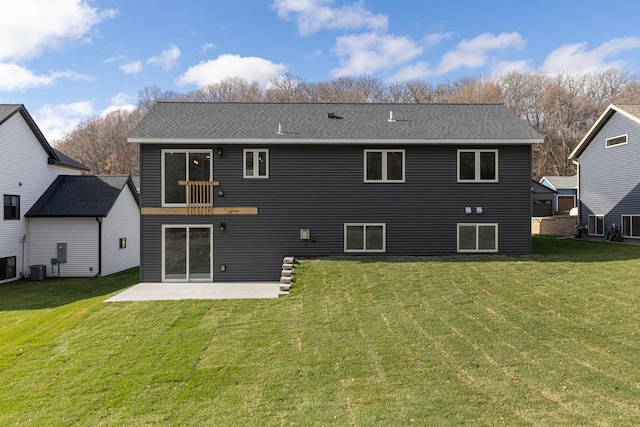 rear view of property featuring a lawn, central AC, and a patio area