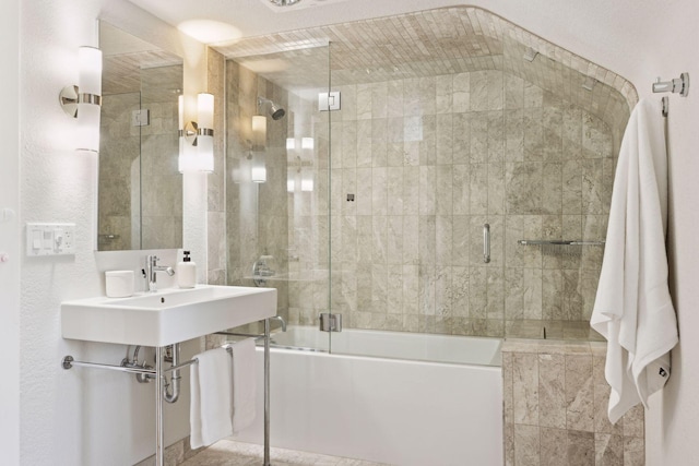 bathroom featuring shower / bath combination with glass door