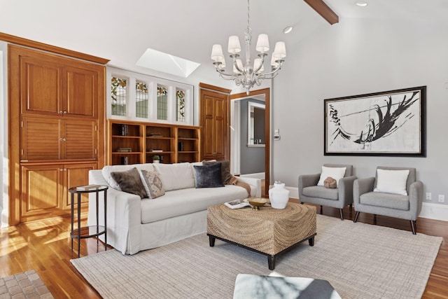 living area with baseboards, light wood-style flooring, an inviting chandelier, high vaulted ceiling, and beam ceiling