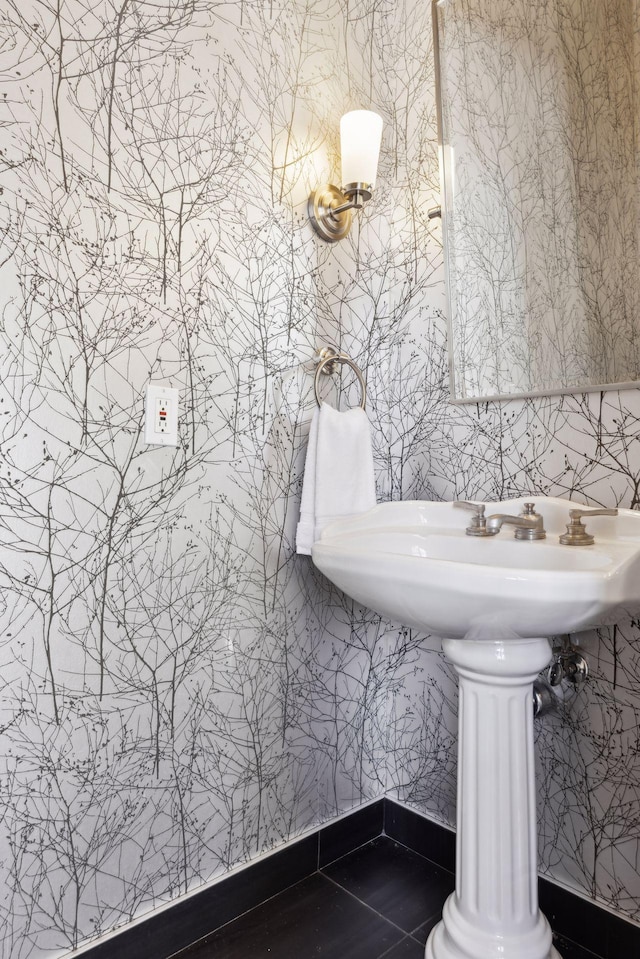 bathroom with wallpapered walls, tile patterned flooring, and baseboards