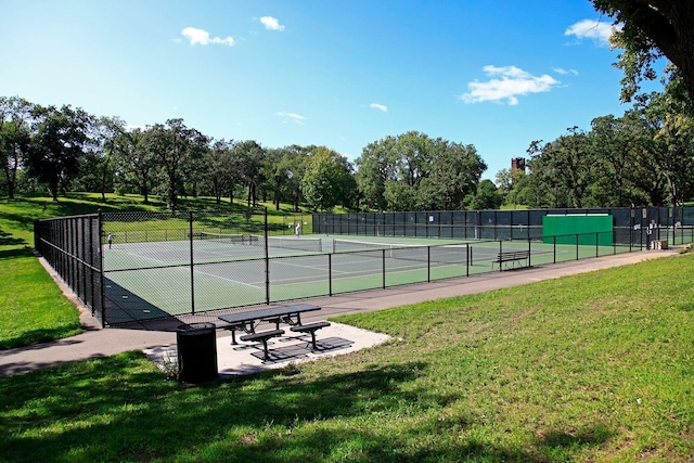 view of sport court with a yard and fence