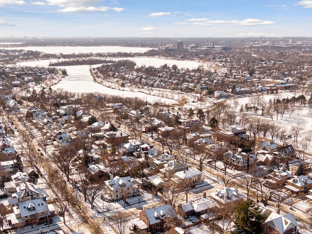 snowy aerial view with a residential view