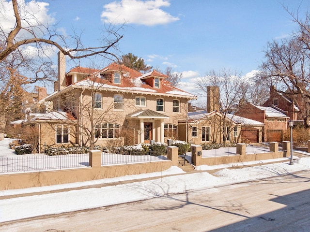 traditional style home featuring a fenced front yard and a chimney