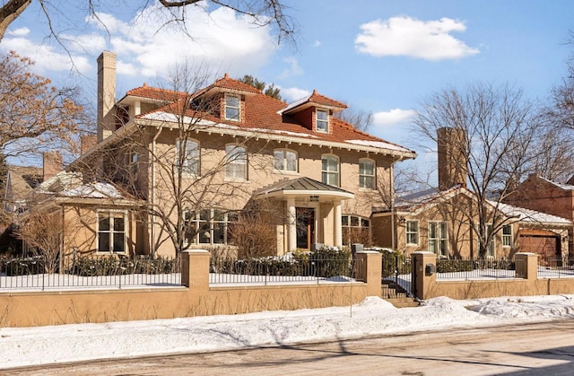 view of front of property featuring a fenced front yard and a chimney