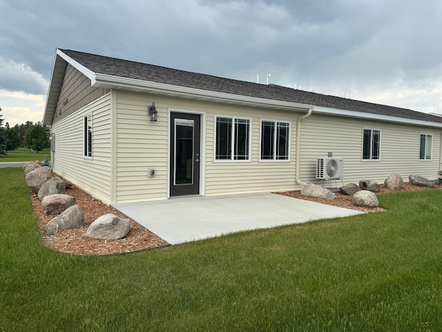 1615 30th St NW Unit 31, Bemidji, MN 56601 - back of property featuring a cooling unit, a lawn, a patio, and roof with shingles