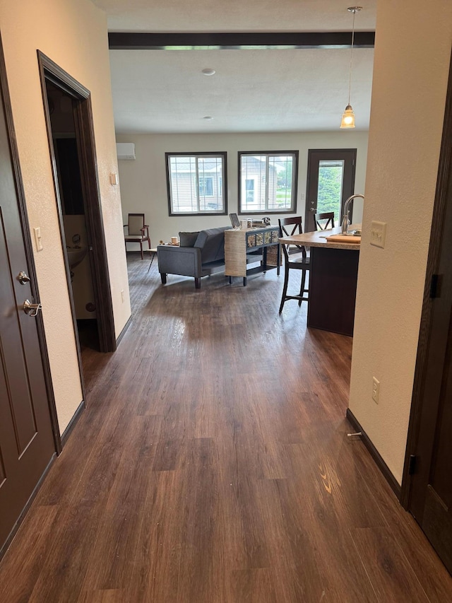 1615 30th St NW Unit 31, Bemidji, MN 56601 - hallway with dark wood-style flooring, plenty of natural light, and a wall unit AC