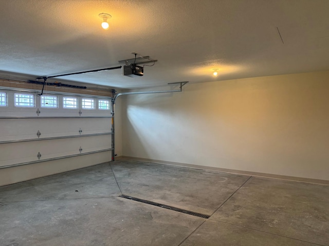 1615 30th St NW Unit 31, Bemidji, MN 56601 - garage featuring a garage door opener and baseboards