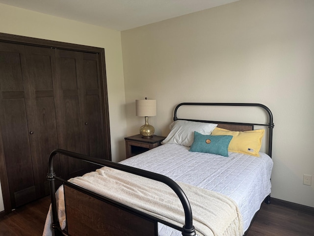 1615 30th St NW Unit 31, Bemidji, MN 56601 - bedroom with dark wood-type flooring, a closet, and baseboards