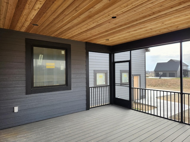 unfurnished sunroom with wooden ceiling