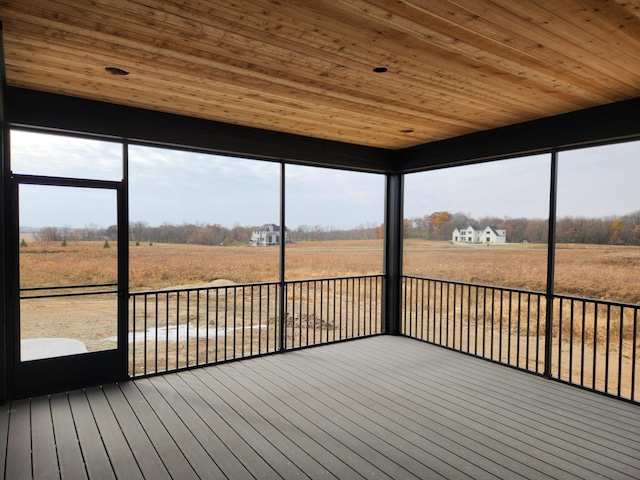 unfurnished sunroom with a rural view and wooden ceiling