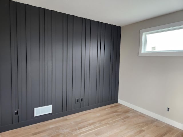 unfurnished room with light wood-type flooring