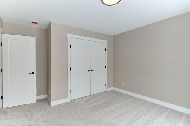 unfurnished bedroom with carpet floors and a closet