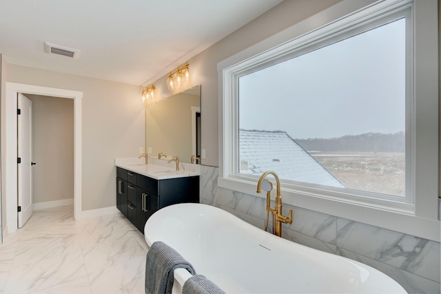 bathroom featuring vanity and a washtub